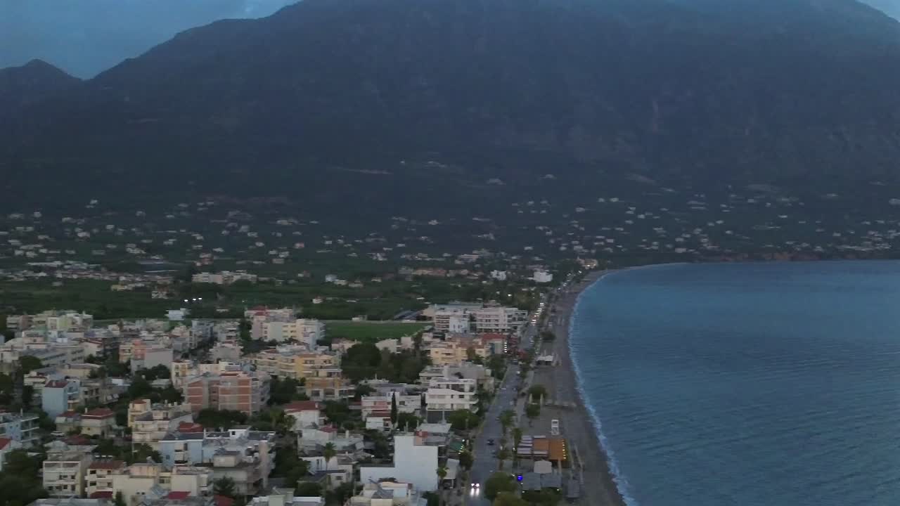 Aerial view , eastern suburbs of Kalamata city, seaside on a cloudy day,Taygetos mountain on background. Slow right pan 4K footage