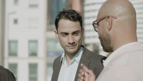 close-up shot of carefree businessmen talking outdoor