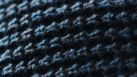 micro video of close up of blue wooly crochet fabric with copy space