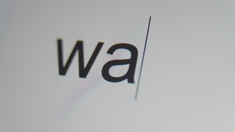 un primer plano de una pantalla digital que muestra un cursor de texto y "guerra" que se está escribiendo