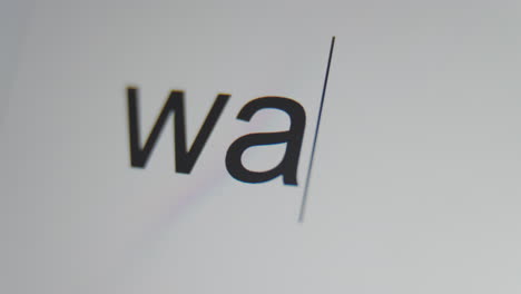 a close up of a digital screen showing a text cursor and "war" being typed