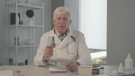 a grey haired, middle aged doctor on an online medical consultation