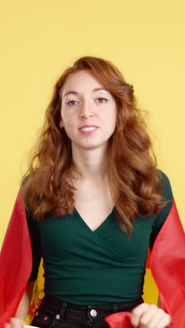 joyful redhead woman celebrating with the spanish flag