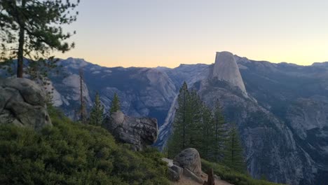 panning left to right view of the iconic half dome at sunrise as viewed from glacier point, yosemite national park, california