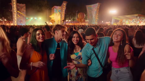 young adults enjoying a lively music festival at night