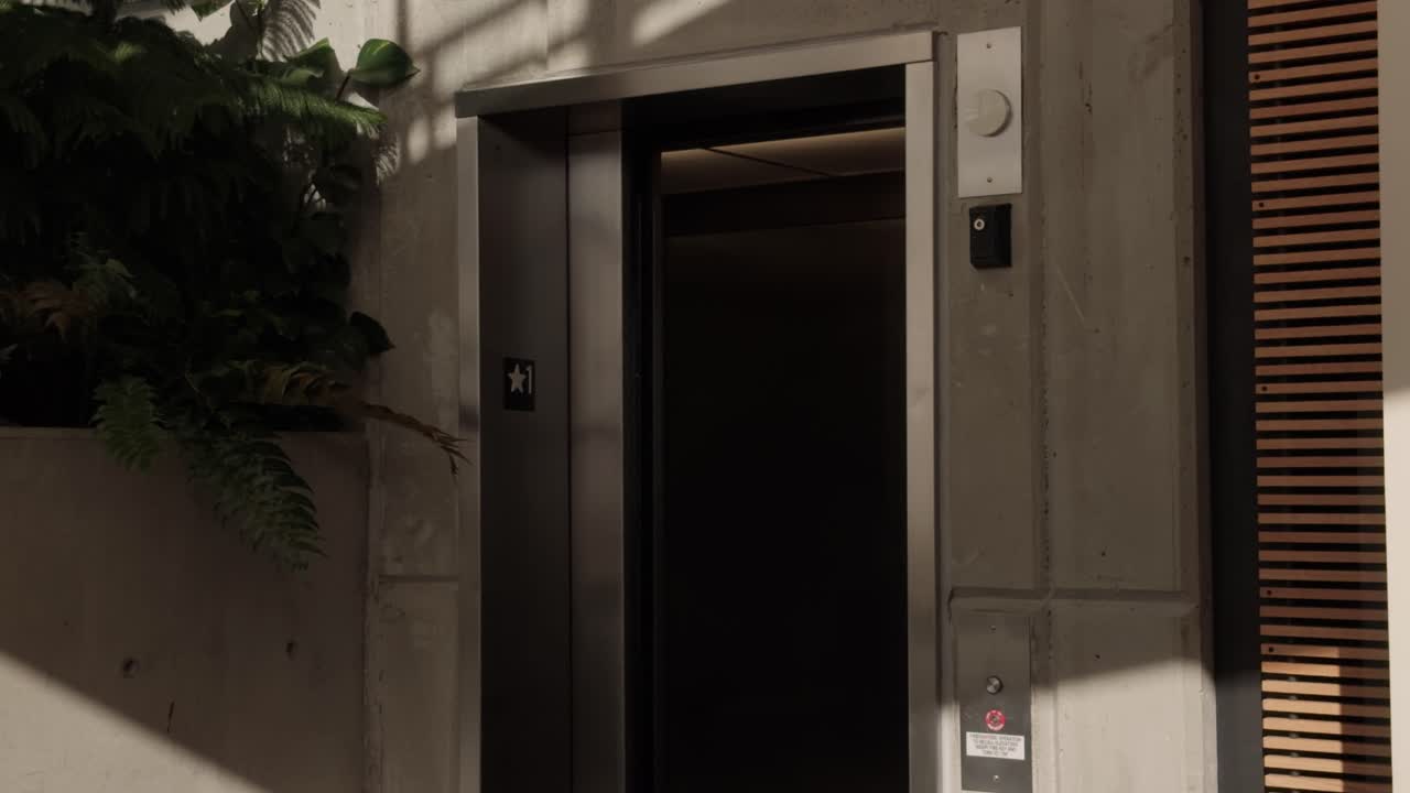 Floaty steady shot of elevator doors closing in lobby
