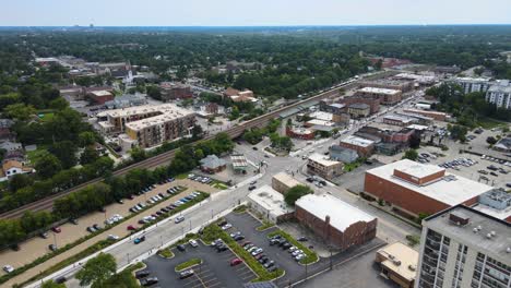 drone shot of lombard, illinois, capturing suburban streets, train tracks, and mixed residential and commercial buildings. crane up right cloudy day sw