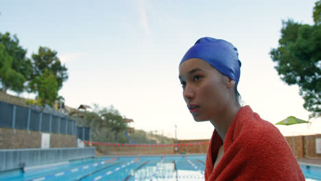 female swimmer sitting near swimming pool 4k