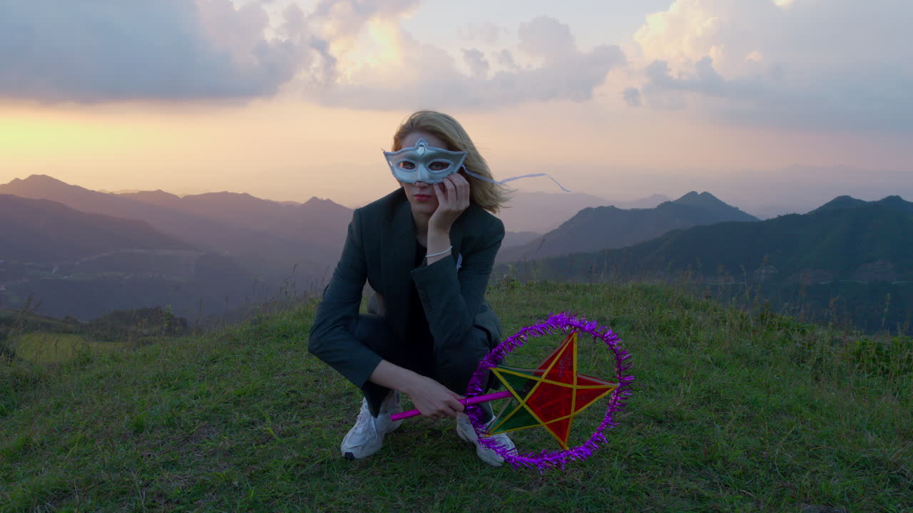 Mysterious Woman in Mask at Sunset in the Mountains