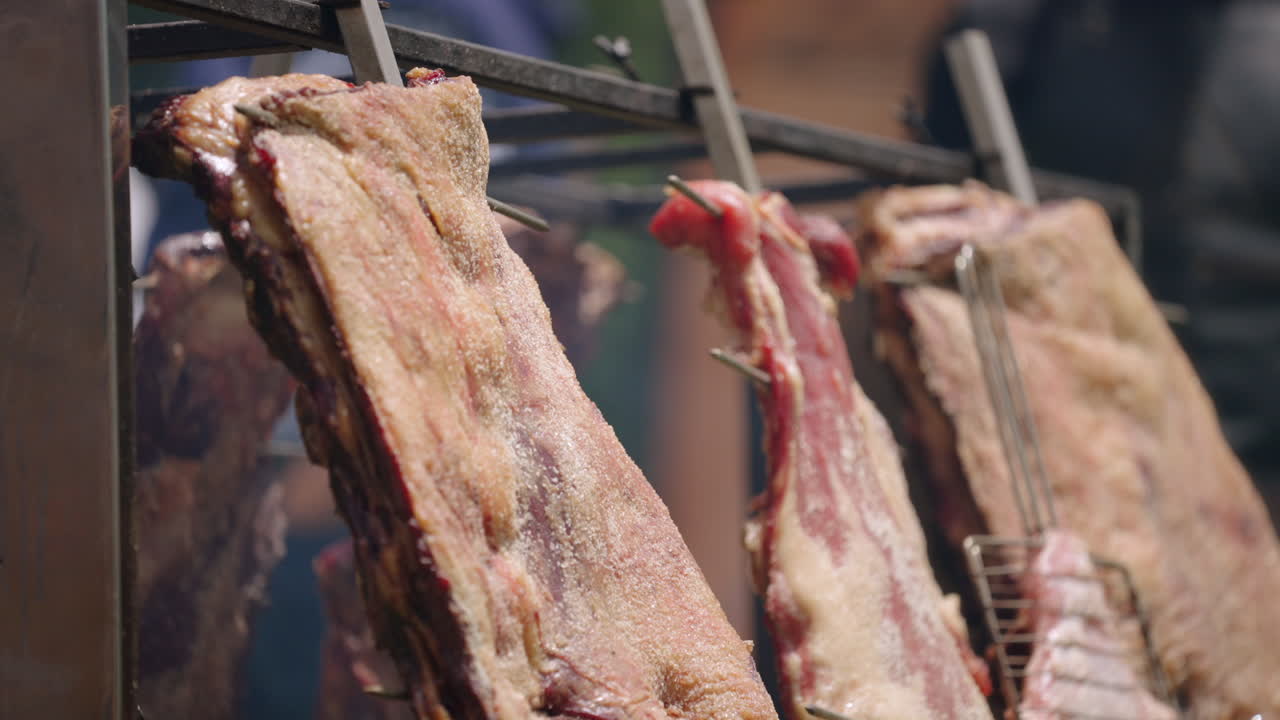 Close-up of traditional Argentinian asado ribs cooking on open fire grill, culinary heritage