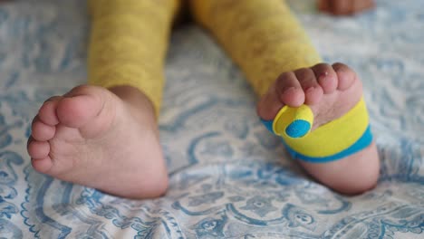 close-up of a toddler's feet in yellow and blue socks