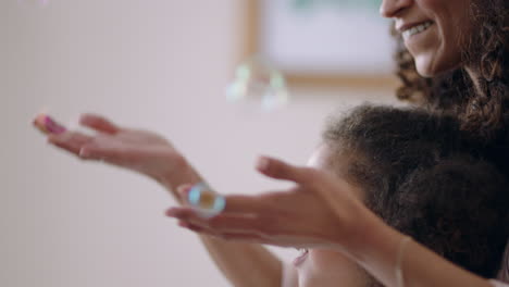 cute-little-girl-playing-with-soap-bubbles-at-home-mother-and-father-having-fun-with-child-at-home-enjoying-family-time-on-weekend