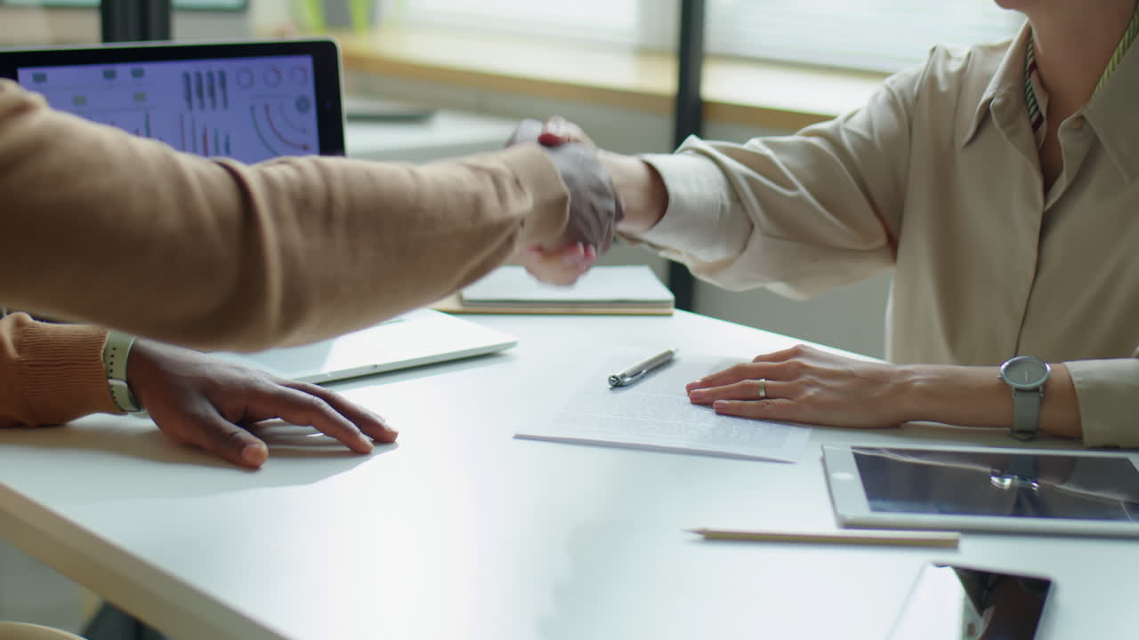 Business Partners Signing Contract and Shaking Hands