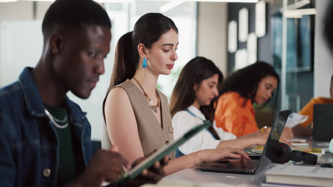 Diverse Group of Young People Working on Laptops and Tablets