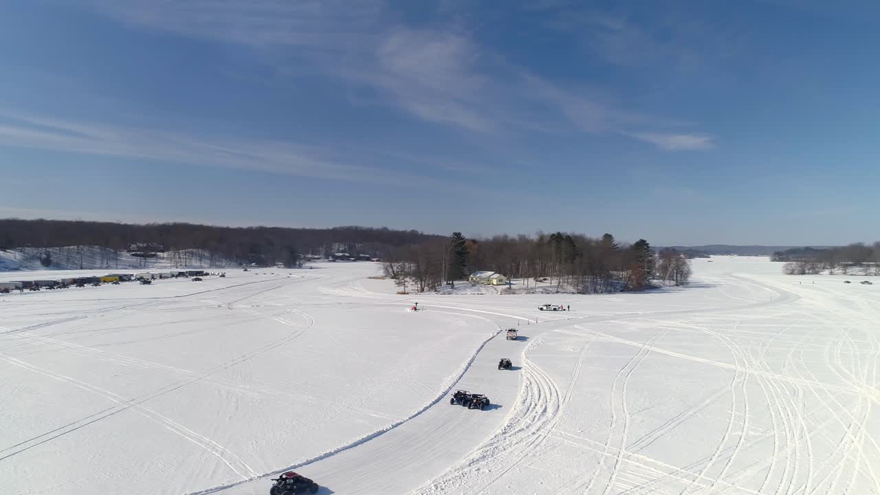 A drone flies over the scene at a special winter racing event