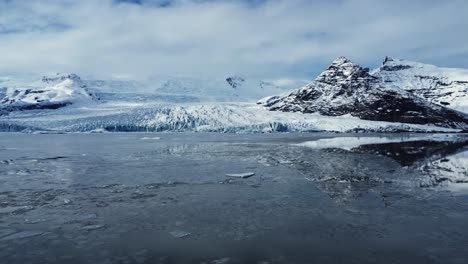 Montañas-Nevadas-Cerca-Del-Glaciar-En-Terreno-Volcánico-Contra-El-Cielo-Nublado