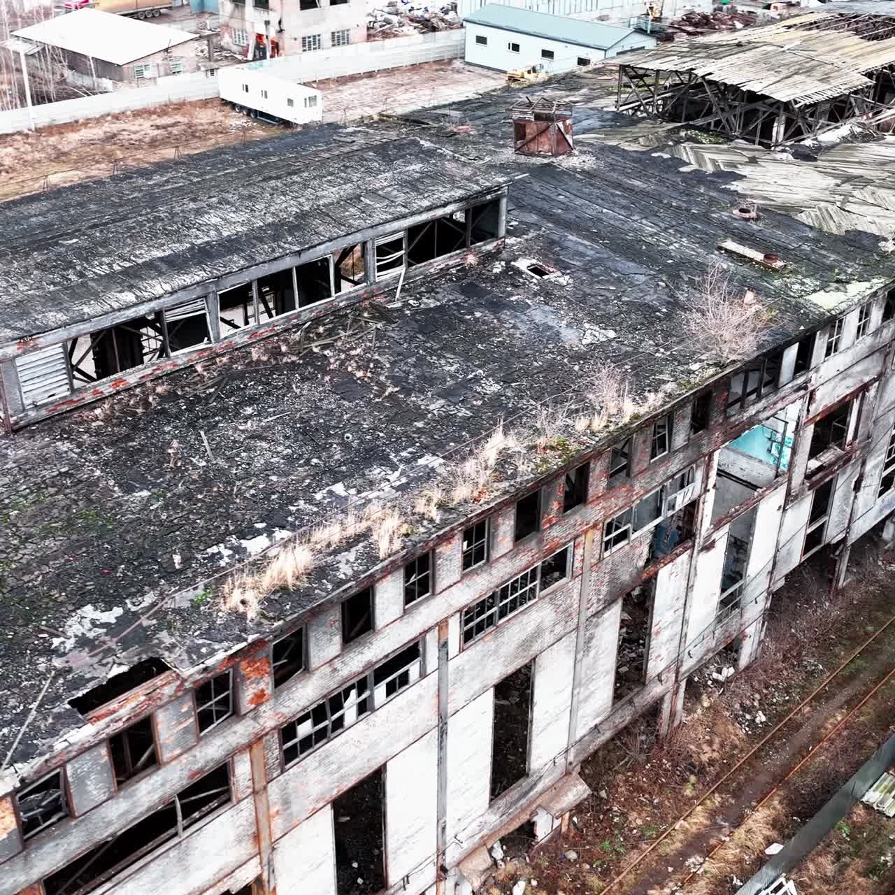 Deserted and solitary industrial zone of a plant destroyed with time. Abandoned territory dangerous for visiting. View from above