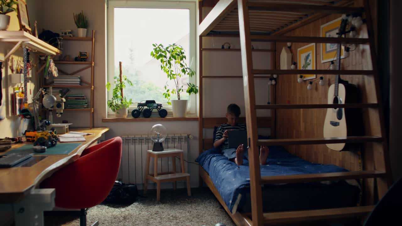 Boy's bedroom with window view and various toys and accessories