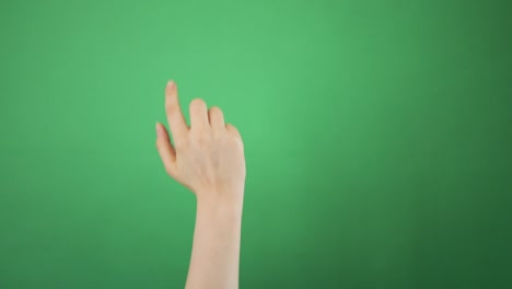 hand touching device screen on green background