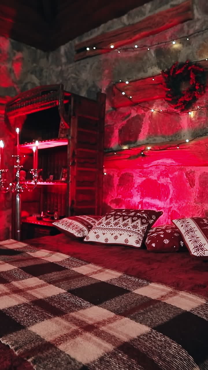 Comfortable bedroom decorated for Christmas. Large bed in cozy room with candlesticks. Romantic background in the house on winter holidays. Vertical video