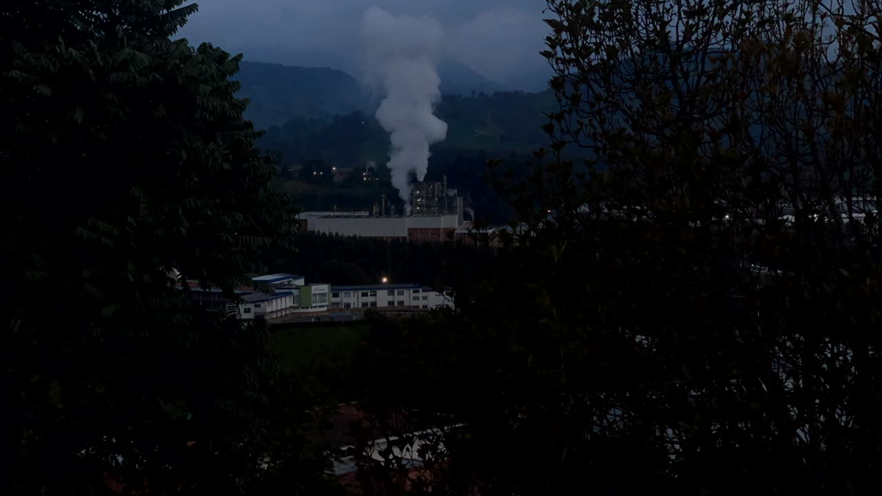 Factory emitting pollution into the atmosphere in natural landscape. Contamination, gas emissions. Smoke,fume. timelapse