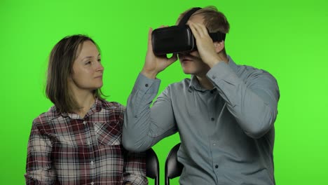 Man-and-woman-using-VR-headset-helmet-to-play-game.-Watching-virtual-reality-3D-video.-Chroma-key