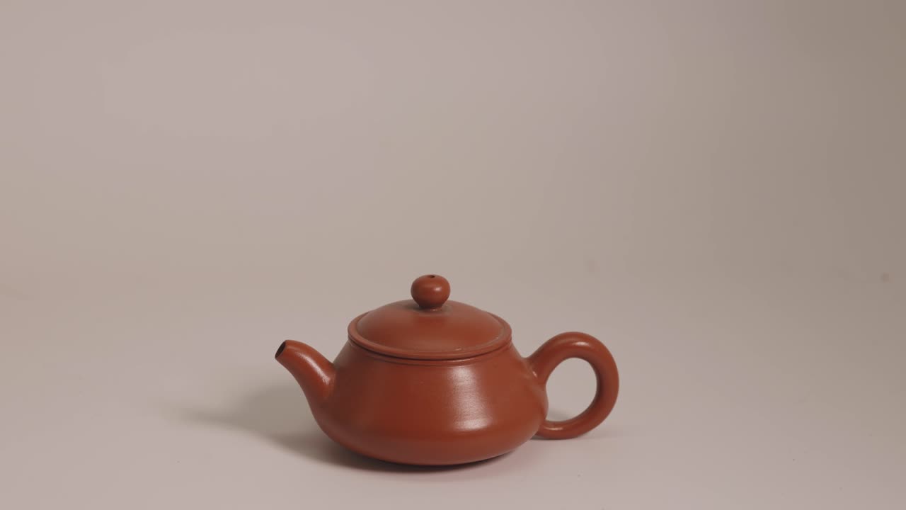 A minimal Red Clay tea pot on a white-background.