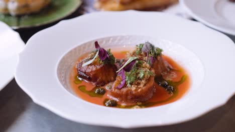 close up panning shot of a delicious italian dish on a round white plate