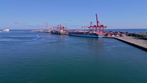 rising tilt aerial shot of container ships at fremantle port, perth, western australia