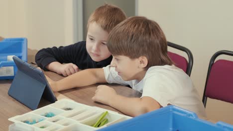 children engage in stem learning activities, assembling robotics kits with focus and teamwork in a classroom setting