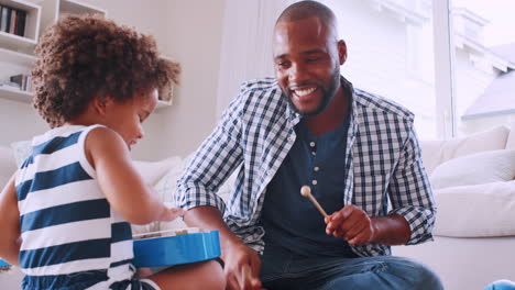 Young-black-dad-and-his-young-daughter-playing-instruments