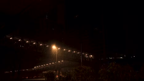 slow-motion of rain over a street light pole