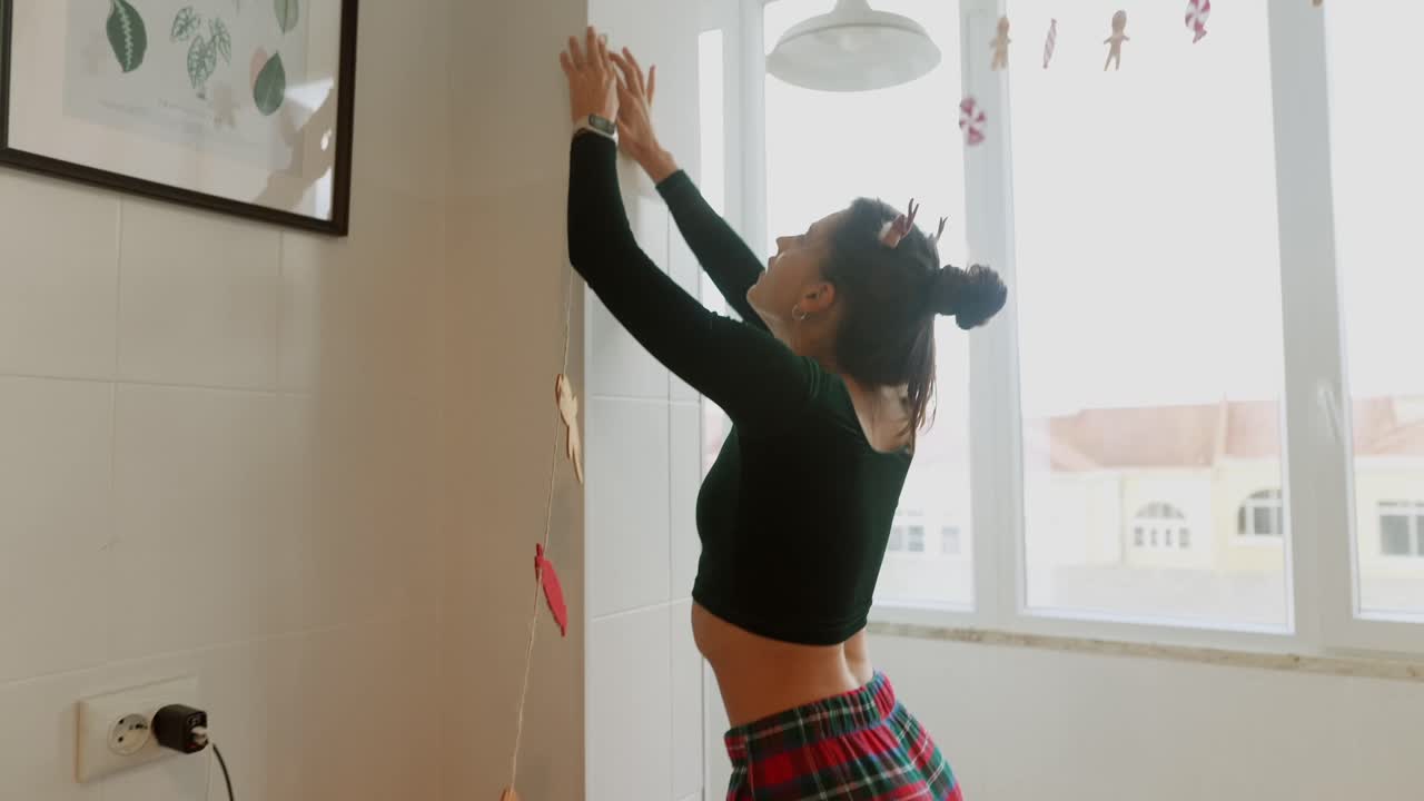 Woman decorating kitchen for Christmas