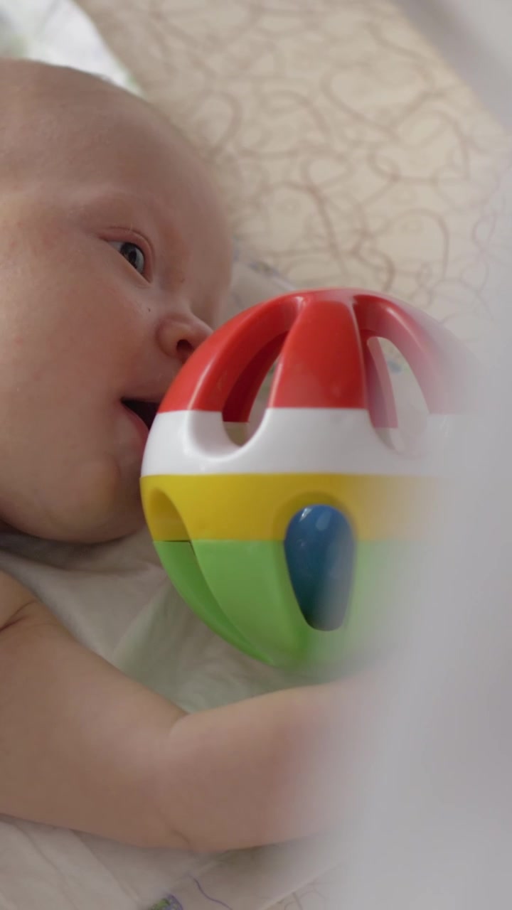 Two months baby and rattle-box toy