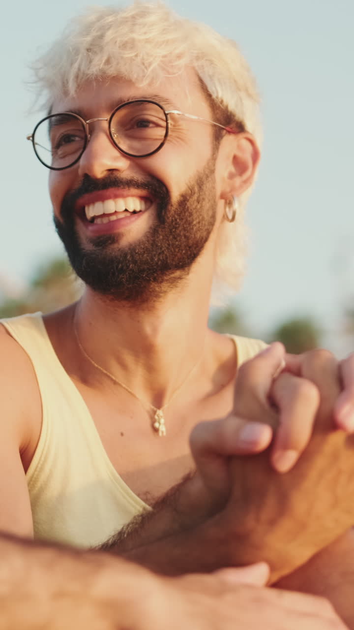 Happy Young Man with Bleached Hair and Glasses Smiling Outdoors
