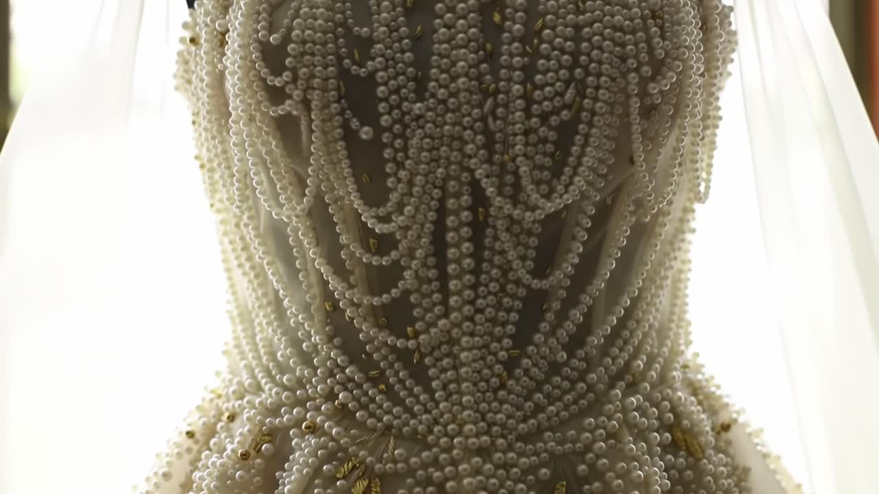 Exquisite Bridal Gown Detailed with Pearls, Showcasing Elegant Design and Intricate Beading, Perfect for the Special Day, Featuring a Breathtaking Silhouette and Classic Charm