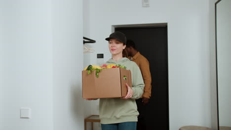 man receiving box of vegetables