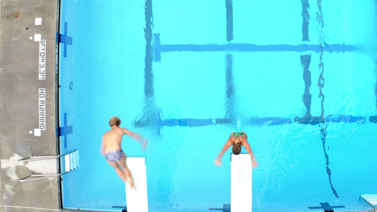 A sequence of two people diving from high boards into a swimming pool, showing the setup, jump, and splash