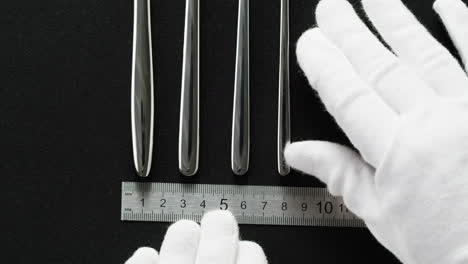 measuring cutlery set with ruler and white gloves