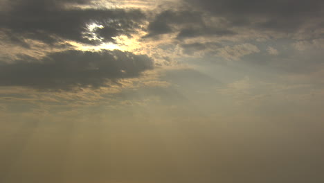 sun beams shining from behind some clouds