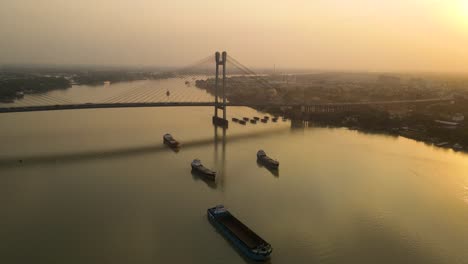 stunning aerial drone capture of vidyasagar bridge during a colorful sunset over the hooghly river.