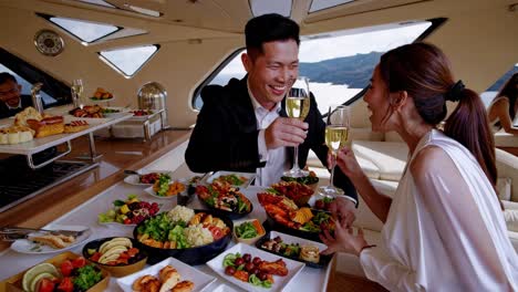 couple celebrating on a yacht with buffet dinner