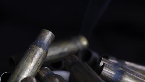 close-up of a pile of smoking gun shell casings