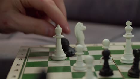 close-up hand playing chess indoor.