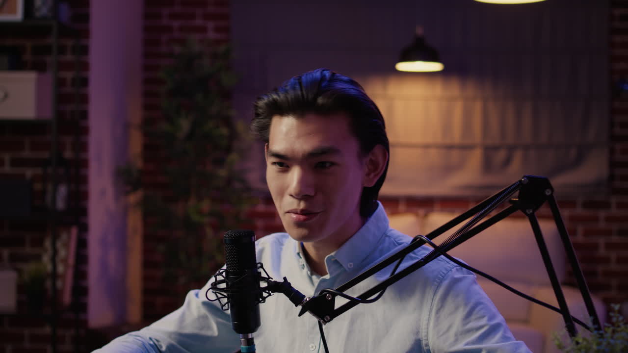 Asian man hosting a podcast in a studio