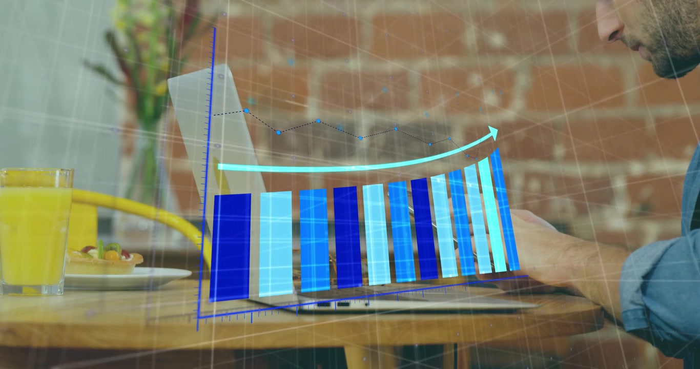 Freelancer placing smartphone by laptop and initiating animated bar graph tracking tech data trend