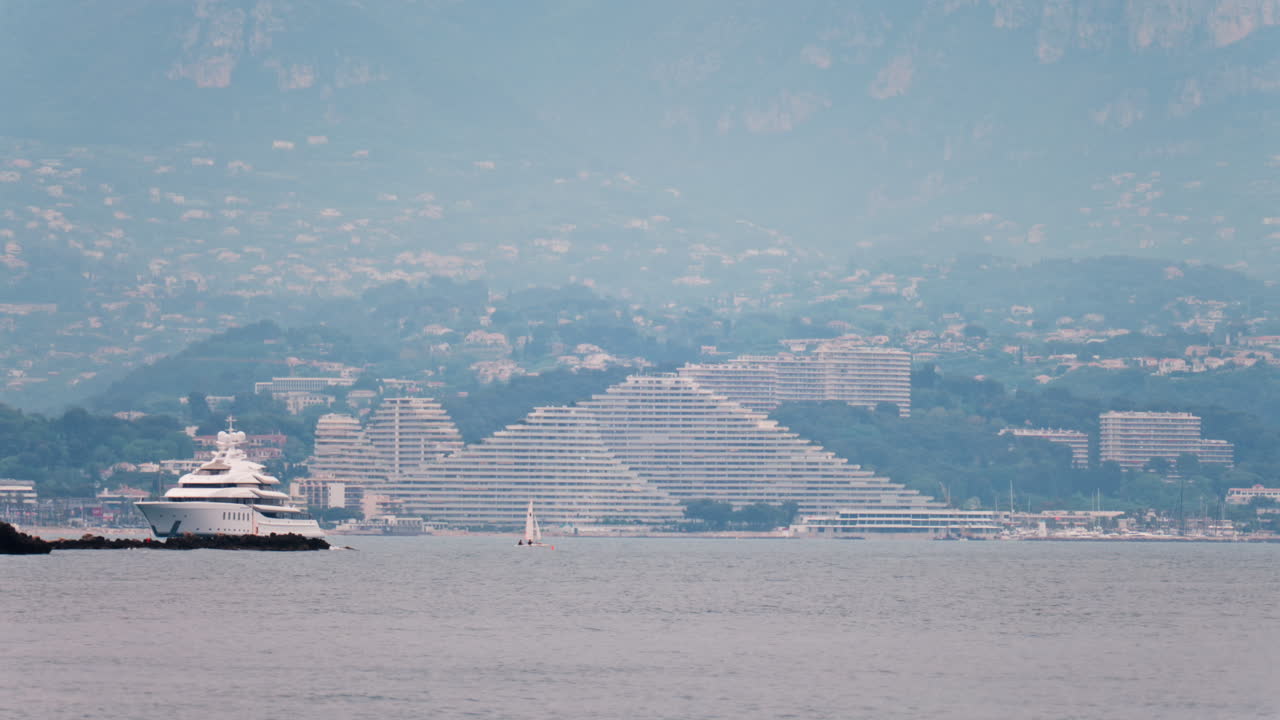 Distant view of a yacht docked near the Marina Baie des Anges in Villeneuve-Loubet, France