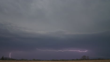 lightning flickers beneath a looming storm, casting an eerie glow over the darkening horizon - static shot