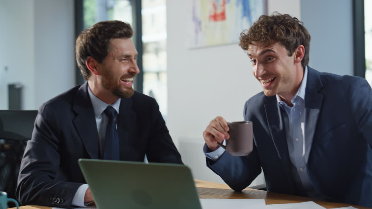 Relaxed colleagues discussing agreement cabinet closeup. Partners shaking hands