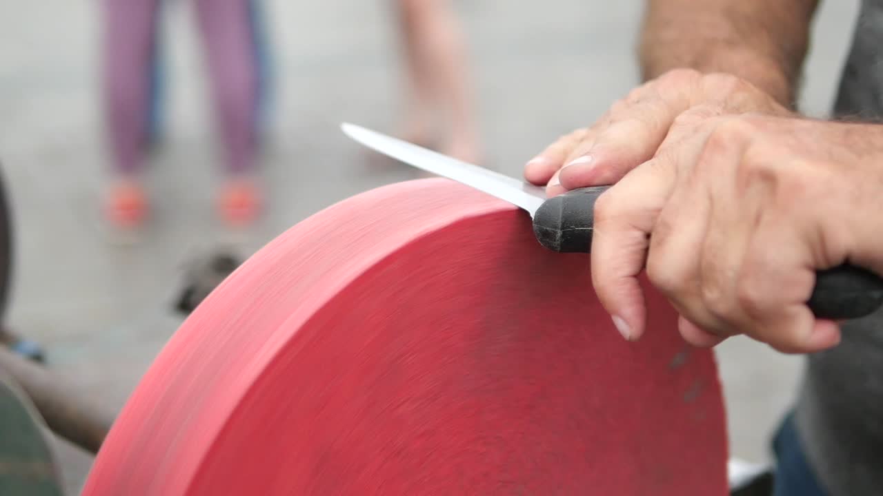 Sharpening a knife with a grindstone